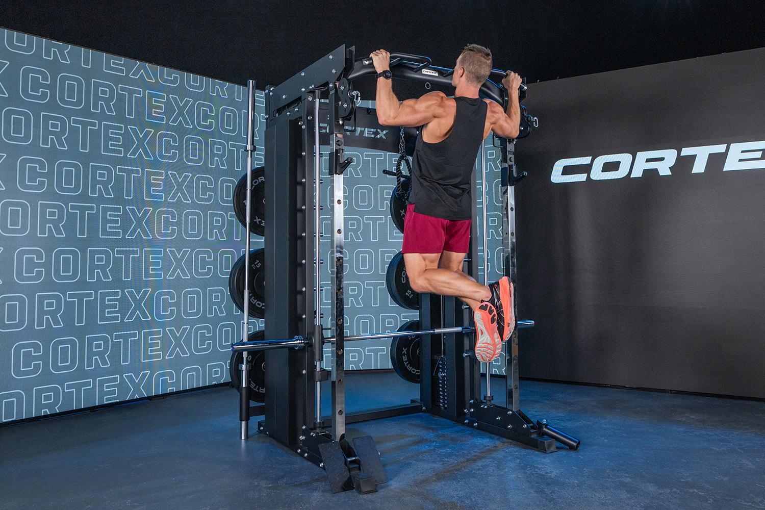 Image of someone using a large gym station in gym room