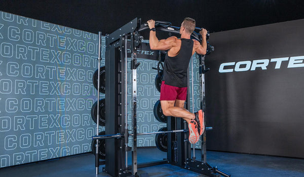  Image of someone using a large gym station in gym room 
